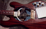 The 6 key system mounted on the cover plate of the guitar
